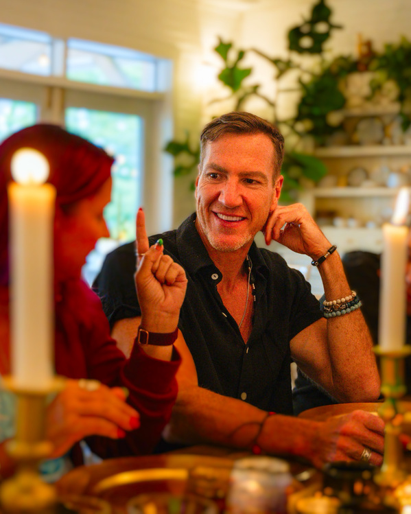 A warm, candlelit moment of conversation